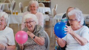 Family member reviewing a care plan with an older adult at an assisted living table